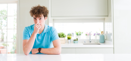 man at home smelling something